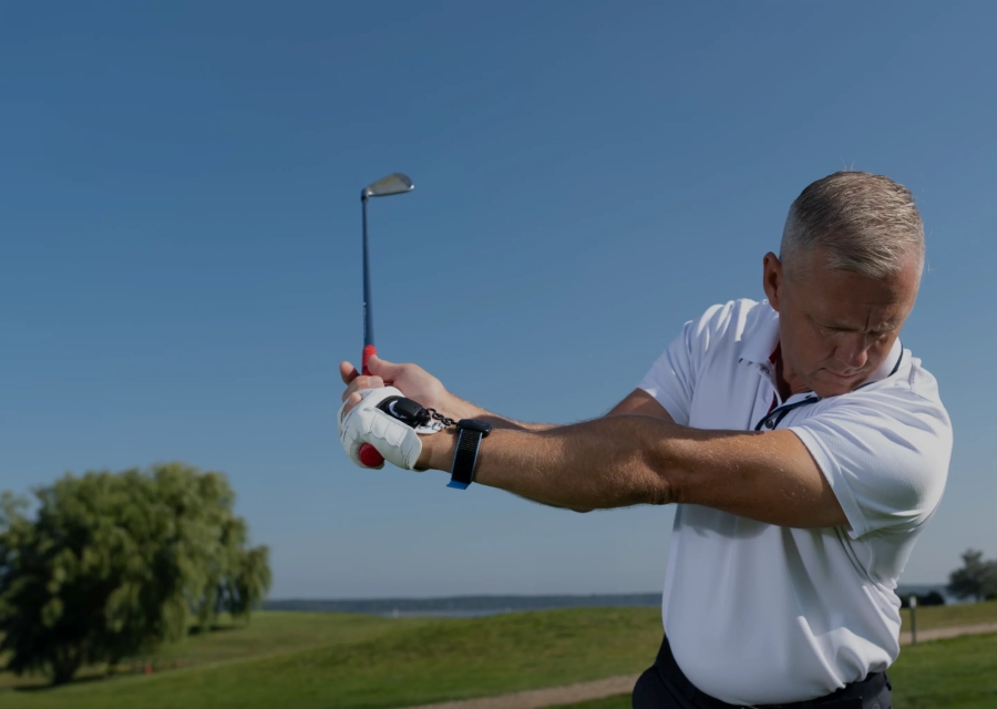 golfer hitting with iron and having flat wrist at the top