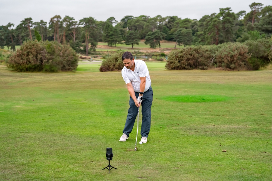 golfer hitting with iron and training with HackMotion wrist sensor